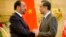 FILE - Afghan Foreign Minister Salahuddin Rabbani, left, and Chinese Foreign Minister Wang Yi, right, shake hands at the end of a joint press conference at the Ministry of Foreign Affairs in Beijing, Jan. 26, 2016.