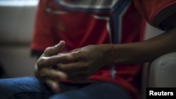 FILE - The hands of a Rohingya victim of trafficking are seen as he listens to questions during an interview with the Thomson Reuters Foundation at a temporary shelter in Hat Yai, Songkla, Thailand.