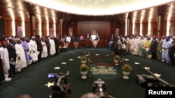 Nigeria's President Muhammadu Buhari swears in ministers into his cabinet in Abuja, Nov. 11, 2015. Buhari swore 36 ministers into his cabinet, five months after his inauguration. 