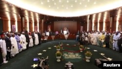 FILE - Nigeria's President Muhammadu Buhari swears in ministers into his cabinet in Abuja, Nov. 11, 2015.