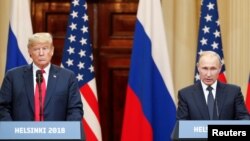 U.S. President Donald Trump and Russian President Vladimir Putin hold a joint news conference after their meeting in Helsinki, July 16, 2018. 