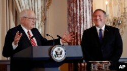 Secretary of State Mike Pompeo (R) listens as President of the World Food Prize Foundation and former U.S. Ambassador to Cambodia, Kenneth M. Quinn (L), speaks during the announcement of the World Food Prize Laureate at the State Department, June 10, 2019