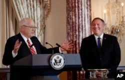 Secretary of State Mike Pompeo (R) listens as President of the World Food Prize Foundation and former U.S. Ambassador to Cambodia, Kenneth M. Quinn (L), speaks during the announcement of the World Food Prize Laureate at the State Department, June 10, 2019