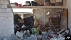 This picture taken Wednesday, Nov. 19, 2014 shows the interior of a destroyed home in Kobani, Syria. Here, Kurdish fighters backed by small numbers of Iraqi peshmerga forces and Syrian rebels, are locked in what they see as an existential battle against t
