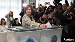 Moldova's incumbent President and presidential candidate Maia Sandu casts her ballots at a polling station as the country holds presidential elections and a referendum on joining the European Union, in Chisinau, Moldova, Oct. 20, 2024.