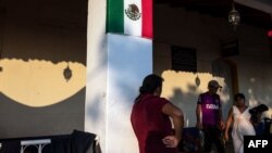 A pregnant Honduran migrant, part of a caravan heading to the U.S., walks by in San Pedro Tapanatepec in southern Mexico, Oct. 27, 2018.