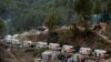 Ambulances wait in line to enter a tunnel where rescue operations are underway to rescue trapped workers, after the tunnel collapsed, in Uttarkashi in the northern state of Uttarakhand, India, Nov. 28, 2023.