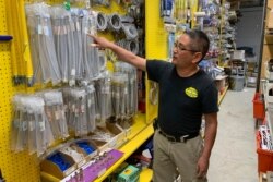 Albert Chow of Great Wall Hardware in San Francisco points to faucet parts, whose prices have increased because of U.S. tariffs on Chinese imports, Aug. 28, 2019. He had to raise the price from $5.49 to $5.99.