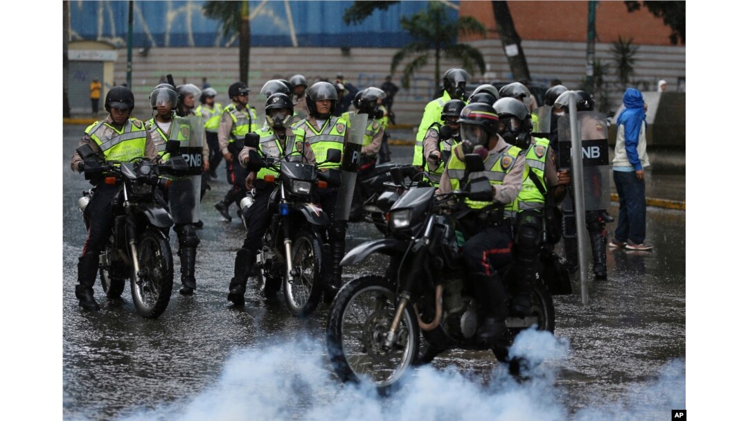 Police ride in to clear a protest in Caracas, Venezuela, June 28, 2017.