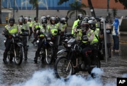 Police ride in to clear a protest in Caracas, Venezuela, June 28, 2017. Protests have continued almost daily for three months, with clashes between Maduro’s foes and his supporters and security forces claiming at least 76 lives.