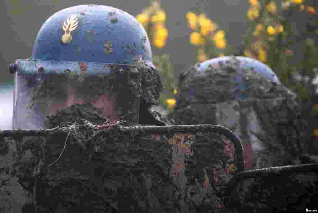 A French gendarme holds his mud-splattered shield during an evacuation operation in the zoned ZAD (Deferred Development Zone) in Notre-Dame-des-Landes, near Nantes, France.