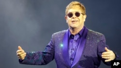 FILE- Musician Elton John performs during a show in Tel Aviv, May 26, 2016. 