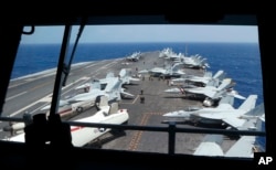 Fighter jets on board the U.S. Navy aircraft carrier USS Carl Vinson (CVN 70) are prepared for patrols off the disputed South China Sea, March 3, 2017.