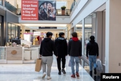FILE - Shoppers walk inside the King of Prussia shopping mall, in King of Prussia, Pennsylvania, Nov. 26, 2021. (REUTERS/Rachel Wisniewski/File Photo)