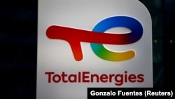 FILE: The logo of French oil and gas company TotalEnergies is pictured at an electric car charging station and petrol station at the financial and business district of La Defense in Courbevoie near Paris. Taken 6.22.2021