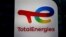 FILE: The logo of French oil and gas company TotalEnergies is pictured at an electric car charging station and petrol station at the financial and business district of La Defense in Courbevoie near Paris. Taken 6.22.2021
