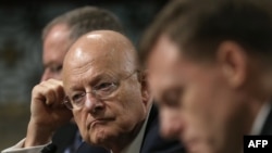Director of National Intelligence James Clapper, center, testifies before the Senate Armed Services Committee in Washington, D.C., Sept. 29, 2015.