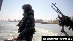 FILE - Ukrainian border guards patrol the Sea of Azov off the city of Mariupol, April 30, 2021.