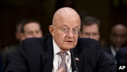 FILE - Director of National Intelligence James Clapper testifies on Capitol Hill in Washington, Feb. 26, 2015. Clapper told a Washington gathering on Thursday that U.S. intelligence agencies are "a pillar of stability."