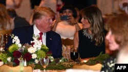 U.S. President Donald Trump and first lady Melania Trump attend a Christmas Eve dinner with his family at Mar-a-Lago in Palm Beach, Fla., Dec. 24, 2019.