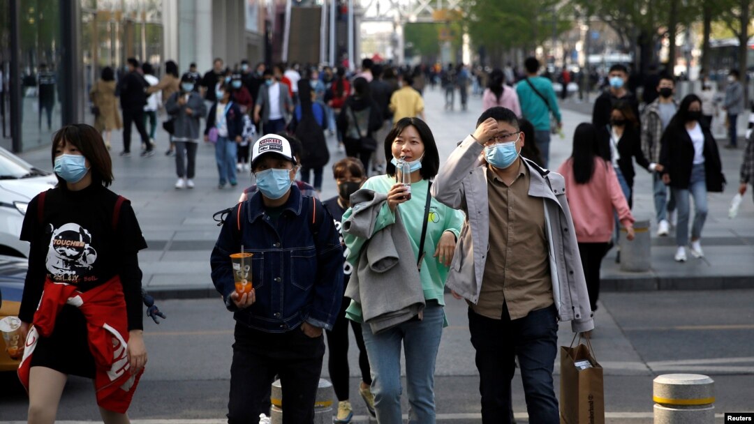 People wearing face masks are seen at a shopping area in Beijing, as the spread of the novel coronavirus disease (COVID-19) continues in the country, China April 6, 2020.