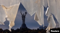 The Motherland monument is seen through a tattered tarpaulin in Kyiv, Ukraine, on Oct. 26, 2023. War correspondent Victoria Roshchyna, who has been covering the Russian invasion of her country, has been missing for nearly three months.