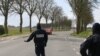 In this photo taken on March 21, 2020 police officers check on motorists in Baisieux, on the Belgian-French boarder, northern France.