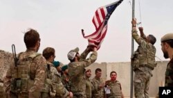 Bendera AS diturunkan dalam upacara yang dihadiri oleh tentara AS dan Afghanistan di Kamp Anthonic, di Provinsi Helmand, di selatan Afghanistan, 2 Mei 2021. 
