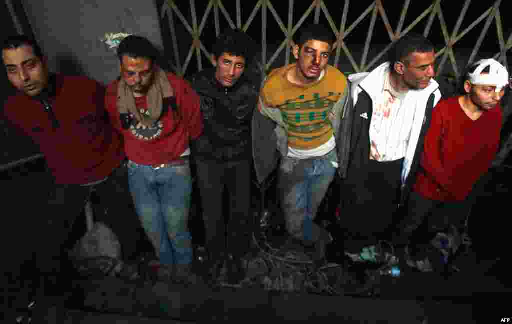 Pro-Mubarak supporters are detained by anti-government protesters after being rounded up during clashes in Cairo's Tahrir Square, February 3, 2011. (Reuters)