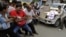 Indian people pull a car by rope and shout slogans during a protest against the price hike in diesel and capping the number of subsidized cooking gas cylinders in Ahmadabad, India, September 14, 2012.