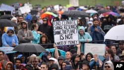 FILE: A person holds a sign that reads "Fund Climate Change Research Saving The Planet Is Not A Waste Of Money" during the March for Science in Washington, April 22, 2017.