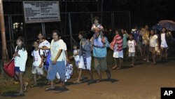 Residents of Tandag city, Surigao Del Sur province in southern Philippines, flee to higher grounds, following a 7.6-magnitude earthquake that struck eastern and southern parts of the country, August 31, 2012.