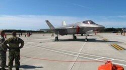 FILE - National Guard members view two F-35 fighter jets that arrived at the Vermont Air National Guard base in South Burlington, Vt., Sept. 19, 2019.