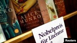 FILE - Books by Canadian writer Alice Munro, the 2013 Nobel Prize in Literature winner, are displayed during the book fair in Frankfurt, Oct. 10, 2013. 