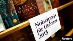 FILE - Books by Canadian writer Alice Munro, the 2013 Nobel Prize in Literature winner, are displayed during the book fair in Frankfurt, Oct. 10, 2013. 