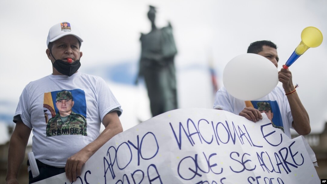 Relatives of the former armed forces members who were accused of being involved in the murder of Haitian President Jovenel Moise, demonstrate in support of their imprisoned loved ones, in Plaza Bolivar, Bogota, Colombia, Aug. 9, 2021. 