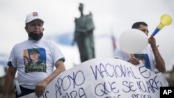 Relatives of the former armed forces members who were accused of being involved in the murder of Haitian President Jovenel Moise, demonstrate in support of their imprisoned loved ones, in Plaza Bolivar, Bogota, Colombia, Aug. 9, 2021. 