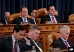 Representative Adam Schiff, a Democrat and the ranking member on the House Intelligence Committee, top left, and Committee Chairman Representaive Devin Nunes, a Republican, upper right, listen during the committee's hearing on allegations of Russian interference in the 2016 U.S. election, on Capitol Hill, March 20, 2017. Schiff has called on Nunes to step away from the Russia investigation.