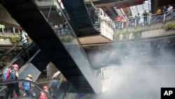 Anti-government demonstrators take shelter in a mall as security forces fire tear gas into it and block their march to the Supreme Court in Caracas, Venezuela, Thursday, July 6, 2017.