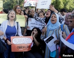 Women chant slogans as they gather to protest against sexual harassment in front of the opera house in Cairo, June 14, 2014, after a woman was sexually assaulted by a mob in Tahrir square.