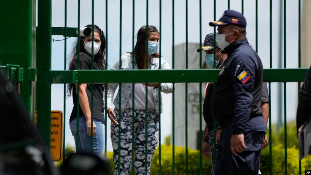 Margareth Baduel, en el centro, hija del difunto ministro de Defensa Raúl Isaías Baduel, habla con la Policía Nacional en la entrada del Cementerio Oriental en Caracas, Venezuela, el miércoles 13 de octubre de 2021.
