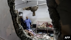 FILE - People inspect the damage in a room following Israeli bombardment at Nasser hospital in Khan Yunis in the southern Gaza Strip on December 17, 2023, amid ongoing battles between Israel and the Palestinian militant group Hamas.