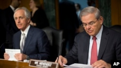 Senate Foreign Relations Committee Chairman Sen. Bob Corker, R-Tenn., left, and the committee's ranking member, Sen. Robert Menendez, D-NJ., prepare for the committee's hearing on Capitol Hill in Washington, March 11, 2015. 