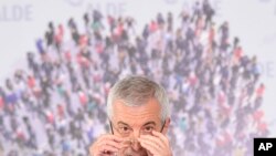 FILE - Calin Popescu Tariceanu, leader of Alliance of Liberals and Democrats and head of Romania's Senate during a press conference in Bucharest, Romania, July 24, 2019.