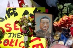 A portrait of George Floyd is part of the memorial for him, Wednesday, May 27, 2020, near the site of the incident.