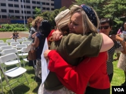 Kelly Oliveira reacts after becoming a U.S. Citizen during a naturalization ceremony in Baltimore, Maryland. (Photo: A. Barros / VOA)