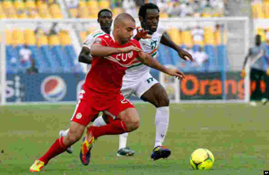 Tunisia's Abdennour is challenged by Niger's Tonji during their African Cup of Nations soccer match in Libreville