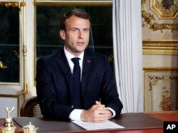 French President Emmanuel Macron addresses the nation at Elysee Palace in Paris following a massive fire at Notre Dame Cathedral, April 16 2019.