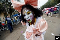 A member of the New Orleans Baby Doll Ladies walks down St. Charles Avenue ahead of the Zulu Parade during Mardi Gras in New Orleans, Feb. 28, 2017.