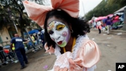 A member of the New Orleans Baby Doll Ladies walks down St. Charles Avenue ahead of the Zulu Parade during Mardi Gras in New Orleans, Feb. 28, 2017.